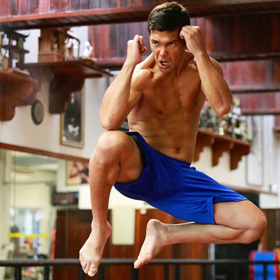 Lyoto Machida doing a jump kick in the gym.